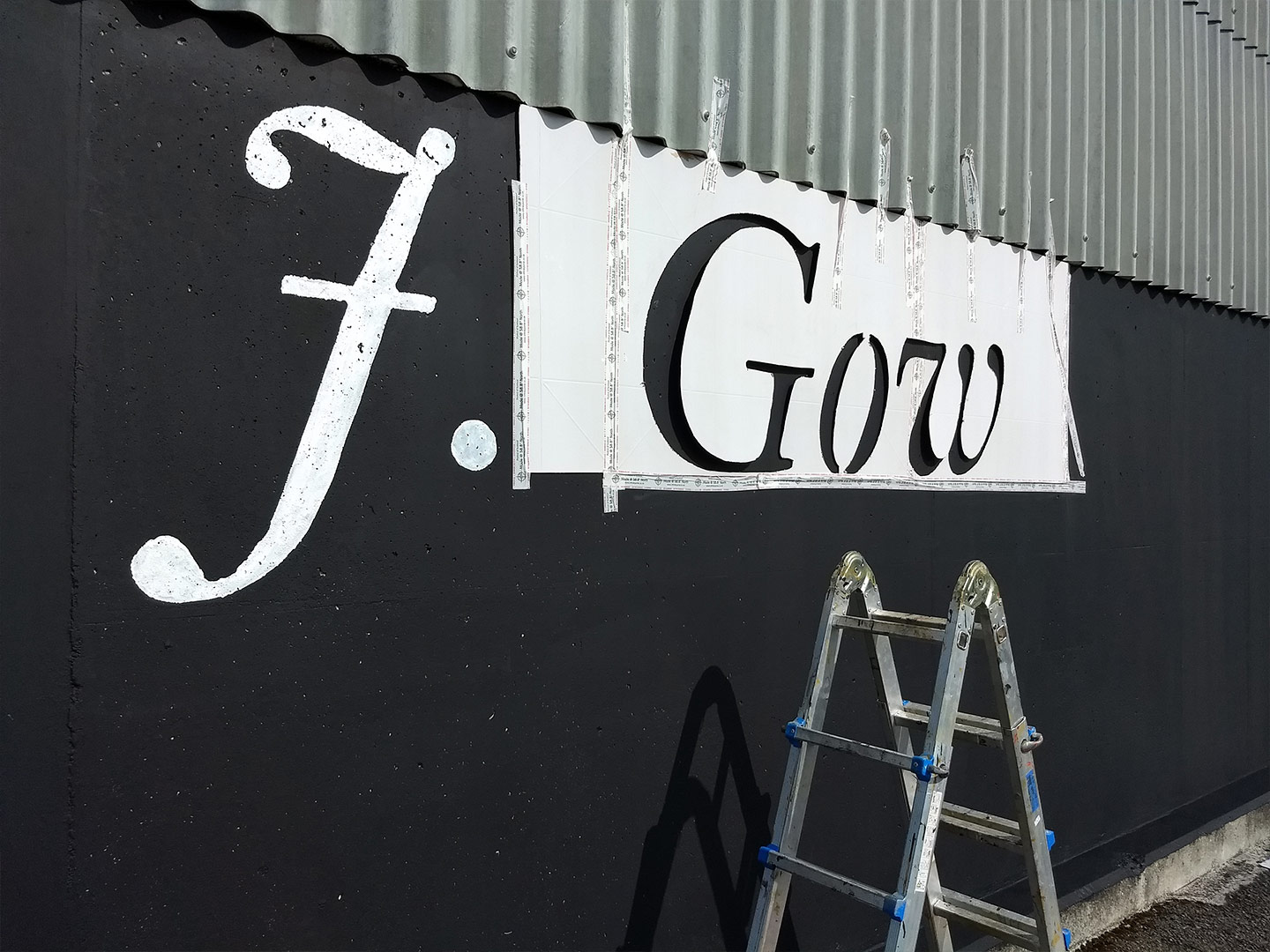 j gow rum distillery being painted